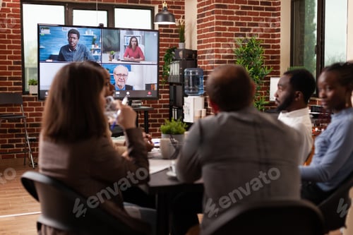 Preview: Diverse businessteam discussing management strategy with remote entrepreneurs