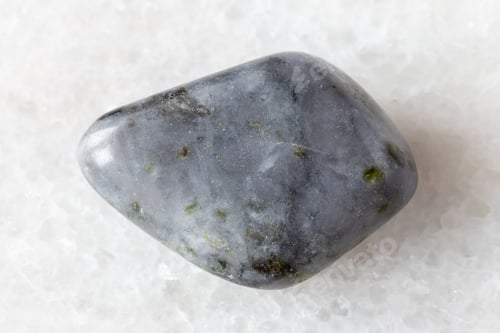 Preview: sample of tumbled melilite rock on white marble