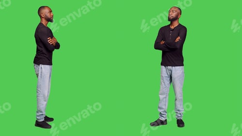 Preview: Confident joyful man posing in front of studio camera
