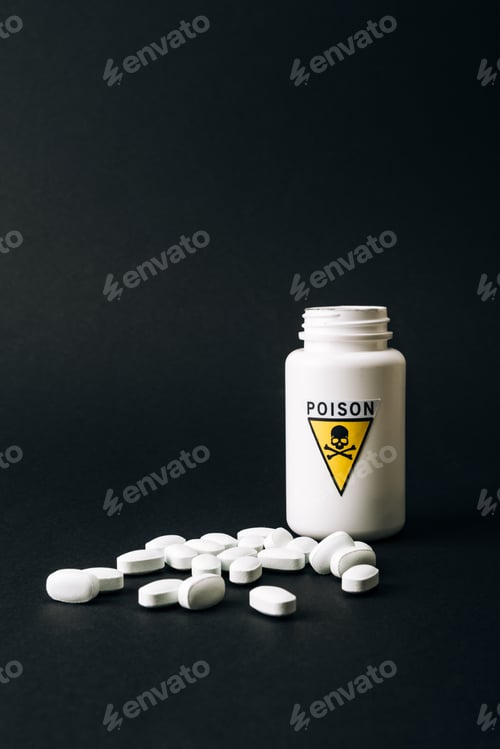 Preview: Bottle with poison sign and pills isolated on black