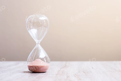 Preview: Hourglass on table, Sand flowing through the bulb of Sandglass measuring the passing time