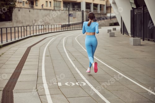 Preview: Beautiful fit caucasian woman is doing exercises outdoors at the city