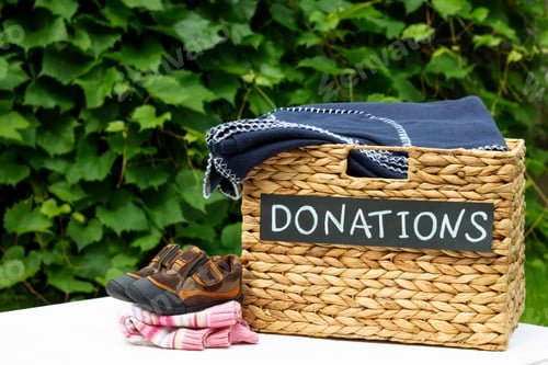 Preview: Donation box for clothing donations on a greenery background. Charity and donation concept. Copy