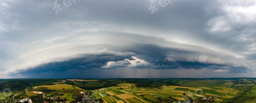 Preview: Landscape of dark clouds forming on stormy sky during thunderstorm over rural area