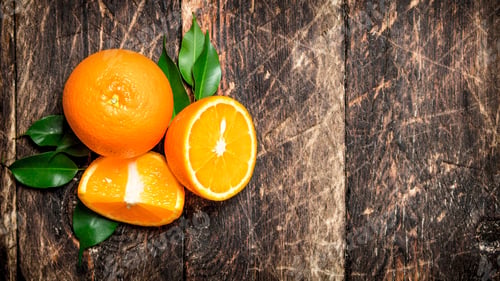Preview: Fresh oranges with green leaves.