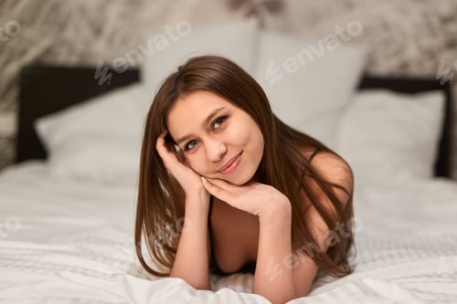 Preview: Alluring smiling woman posing on bed