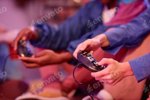 Preview: Close up of young people playing retro video game in neon light