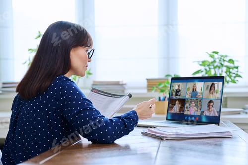 Preview: Woman Participating in Online Meeting at Desk
