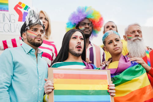 Preview: Group of diverse gay people looking serious at pride parade - Homosexual love and equality concept