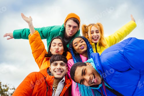 Preview: Multiracial group of young friends meeting outdoors in winter