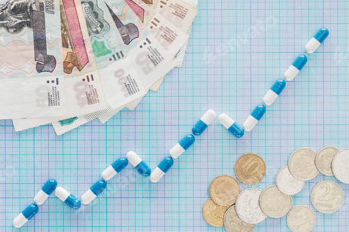 Preview: elevated view of pills graph and russian banknotes with coins on blue checkered surface