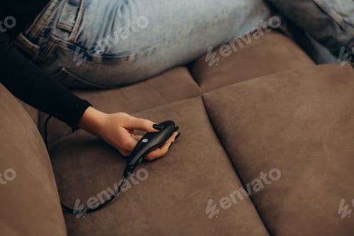 Preview: a woman resting on a sofa with a massager
