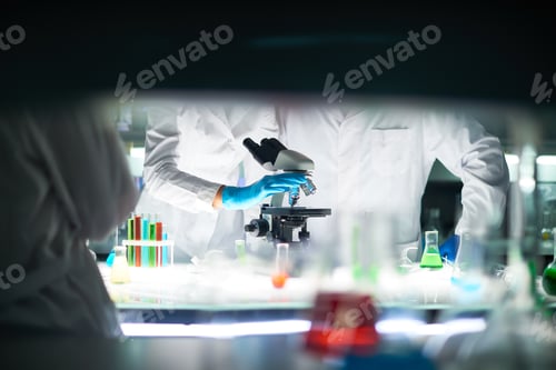 Preview: Medical Scientists Working With Microscope In Laboratory