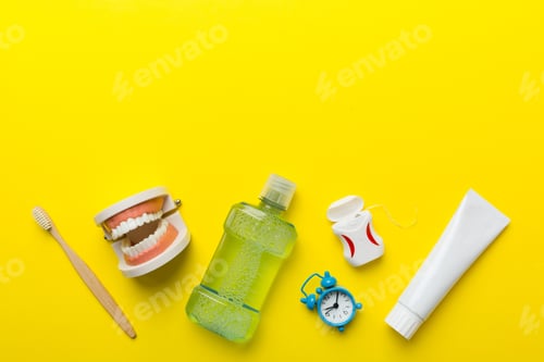 Preview: Mouthwash and other oral hygiene products on colored table top view