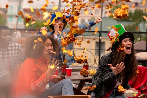 Preview: Multicultural female football fans throwing confetti while cheering