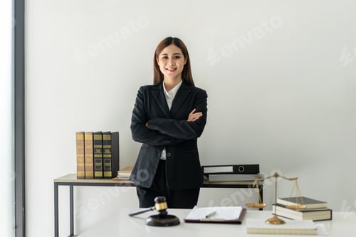 Preview: Business lawyer woman working the legal field on the table with brass scales and justice hammer