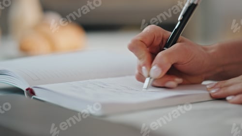 Preview: Woman hands writing notebook holding ballpen closeup. Accountant working laptop