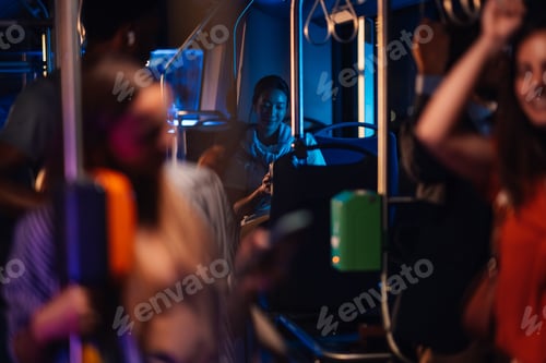 Preview: Young woman using smartphone on night bus ride home