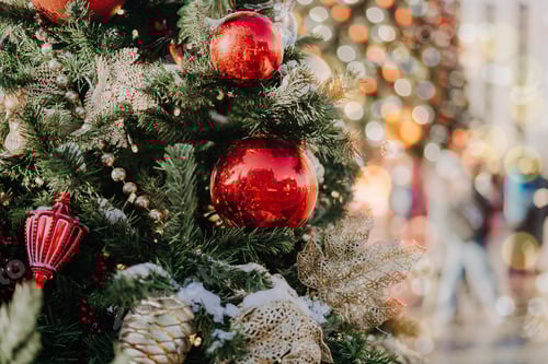 Preview: Close up of balls on christmas fir tree. Bokeh light garlands in background with copy space. Merry