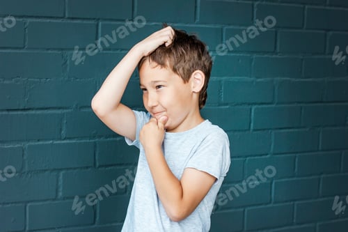 Preview: Boy 8 years old with freckles looking into the distance