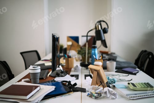 Preview: Messy Office Desk Awaiting Cleaning in Modern Workplace Environment