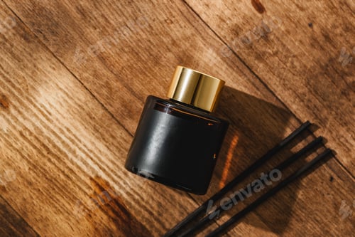 Preview: Elegant Perfume Bottle Bathed in Sunlight on a Wooden Surface