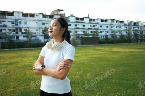 Preview: Young woman relaxing in urban park, finding peace