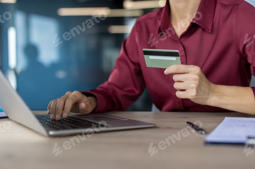 Preview: Woman making online payment with credit card on laptop