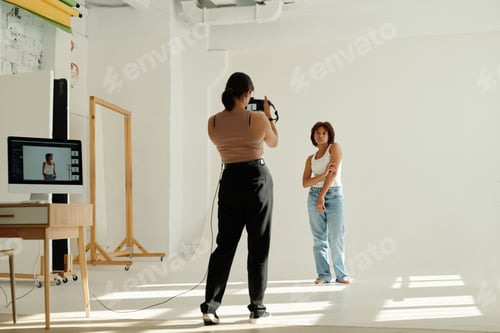 Preview: Long shot of young African American woman posing for camera in studio