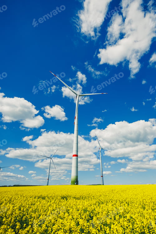 Preview: Wind energy generation using windmills. Electricity is produced by a wind turbine against a blue sky
