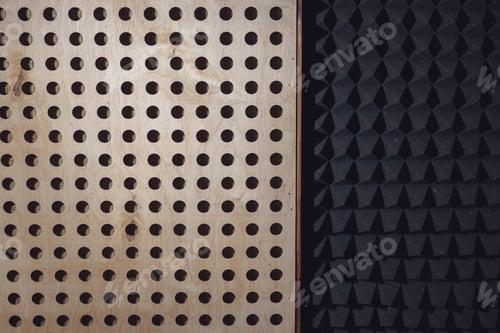Preview: Wooden surface with round holes and black soundproof wall with acoustic dampening foam