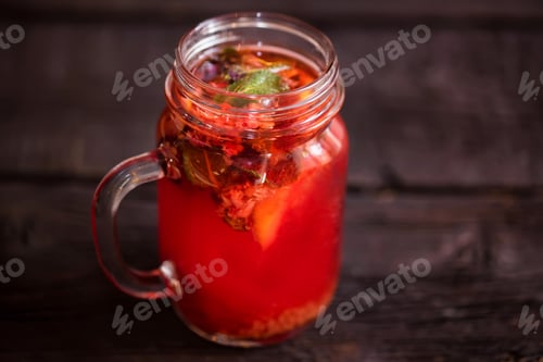 Preview: Close up glass jar with delicious healthy raspberry tea drink