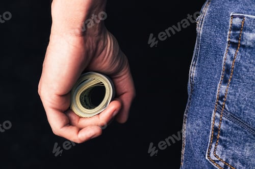 Preview: Roll of hundred us dollars in male fist