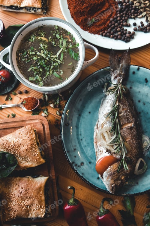 Preview: Fresh fish dorado. Dorado and ingredients for cooking on a table.