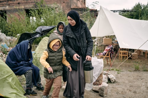Preview: Mother Carrying Thermos Flask Along Refugee Camp