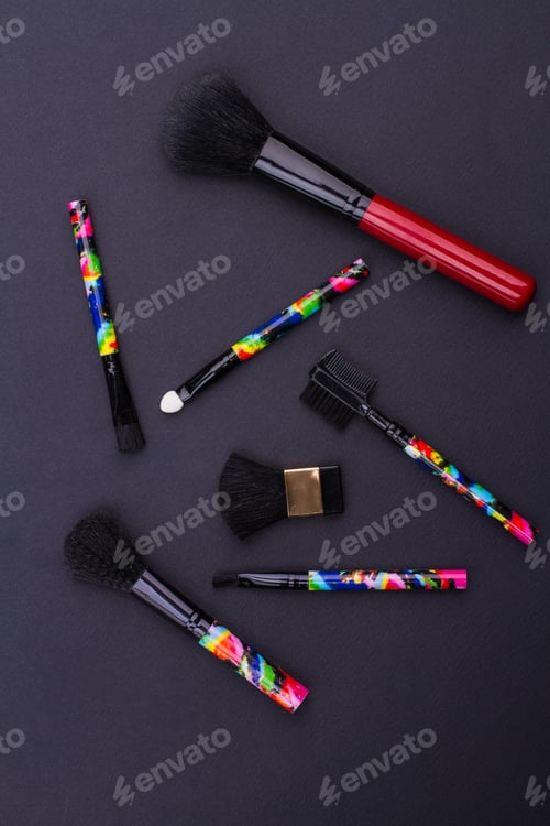 Preview: Close-up of set professional different sizes make-up brushes isolated on black background.