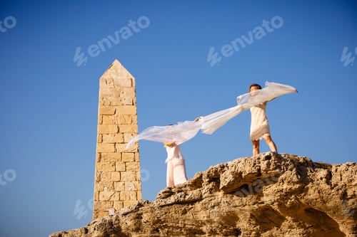 Preview: Young women with textile on stone