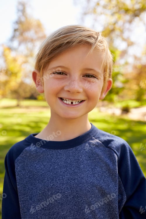 Preview: Seven year old Caucasian boy in a park, vertical portrait