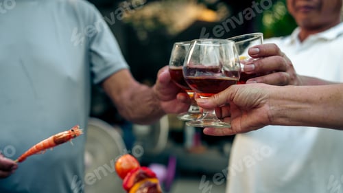 Preview: Home Garden BBQ Party, Wine Glasses Clink in Family Toast, enjoying harvest time together outside at