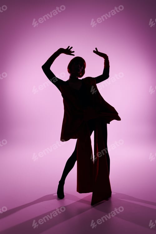 Preview: Striking Young Drag Queen Exudes Confidence in a Bold Pose Against a Pink Background