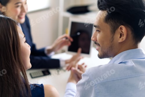 Preview: Investment female adviser giving a presentation to an Asian friendly young couple