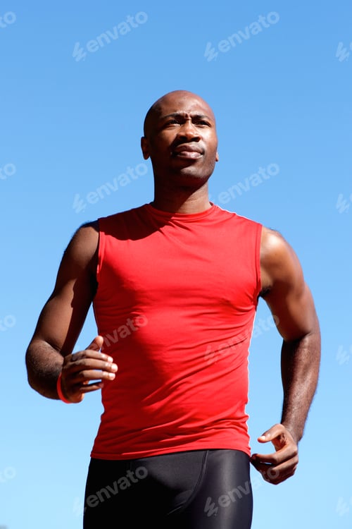 Preview: Young active man running outdoors against sky