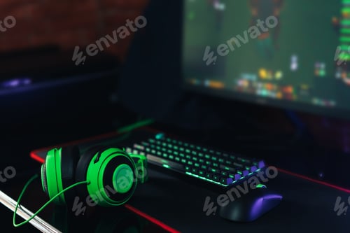 Preview: Gaming accessories with green backlight in front of the monitor