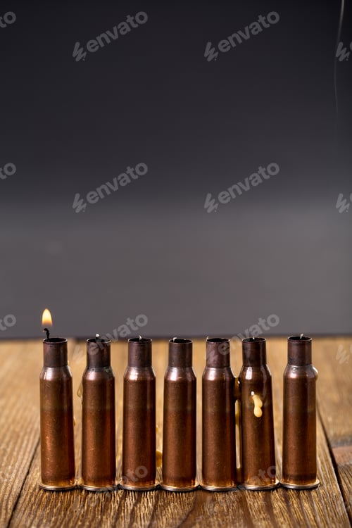 Preview: Burning candles and empty rifle cartridges.