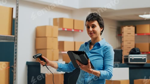 Preview: Young employee scanning products from warehouse