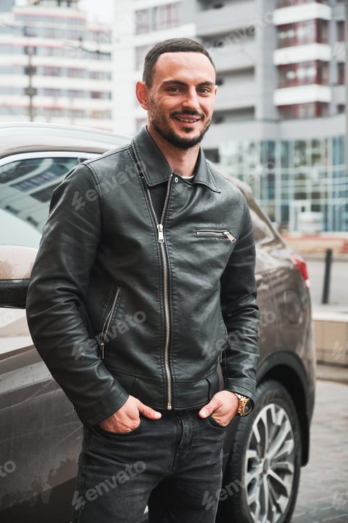 Preview: Young man posing near his modern car