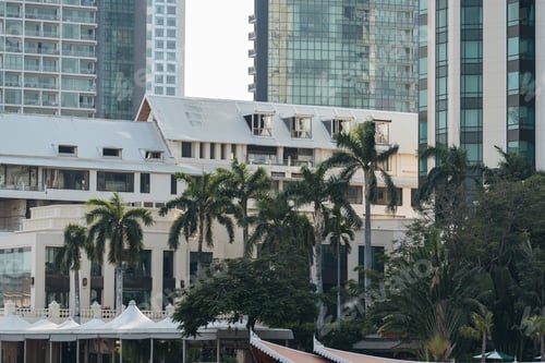 Preview: Tropical Resort Facade Amidst High-Rises.