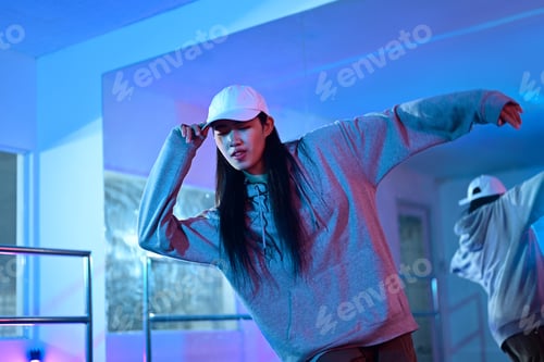 Preview: Young woman training hip hop in dance studio. Dance, hobby, movement, and active lifestyle
