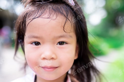 Preview: Close-up portrait of a lovely young girl with a gentle, warm smile.