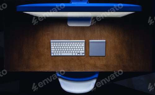 Preview: Computer and keyboard on a wooden table at night, top view.